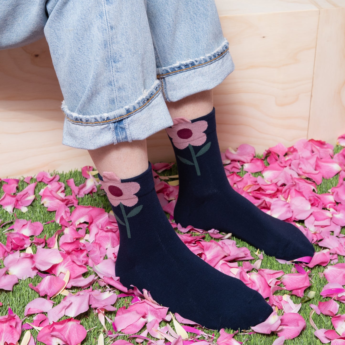 Playful look with navy blue ankle socks, pink flower with jeans