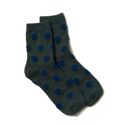 Soft and stylish green ankle socks with detailed small blue polka dots