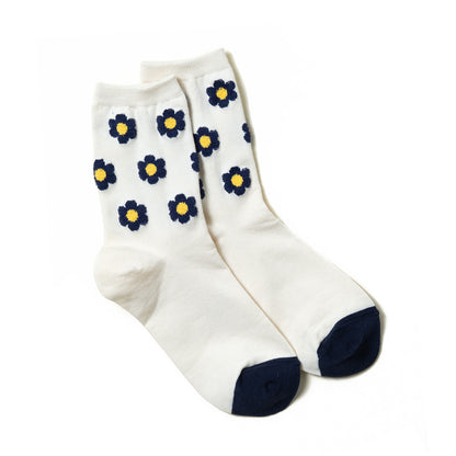 luxurious woman's white ankle sock with navy floral dots pattern and navy toe box