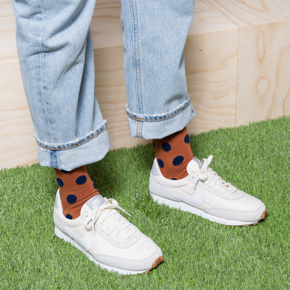 Colorful polka dot ankle socks paired with sneakers for a fun and trendy outfit