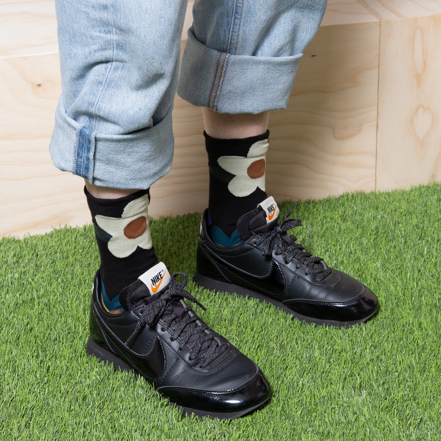 women's ankle socks black with cute white flowers with black nike shoes.