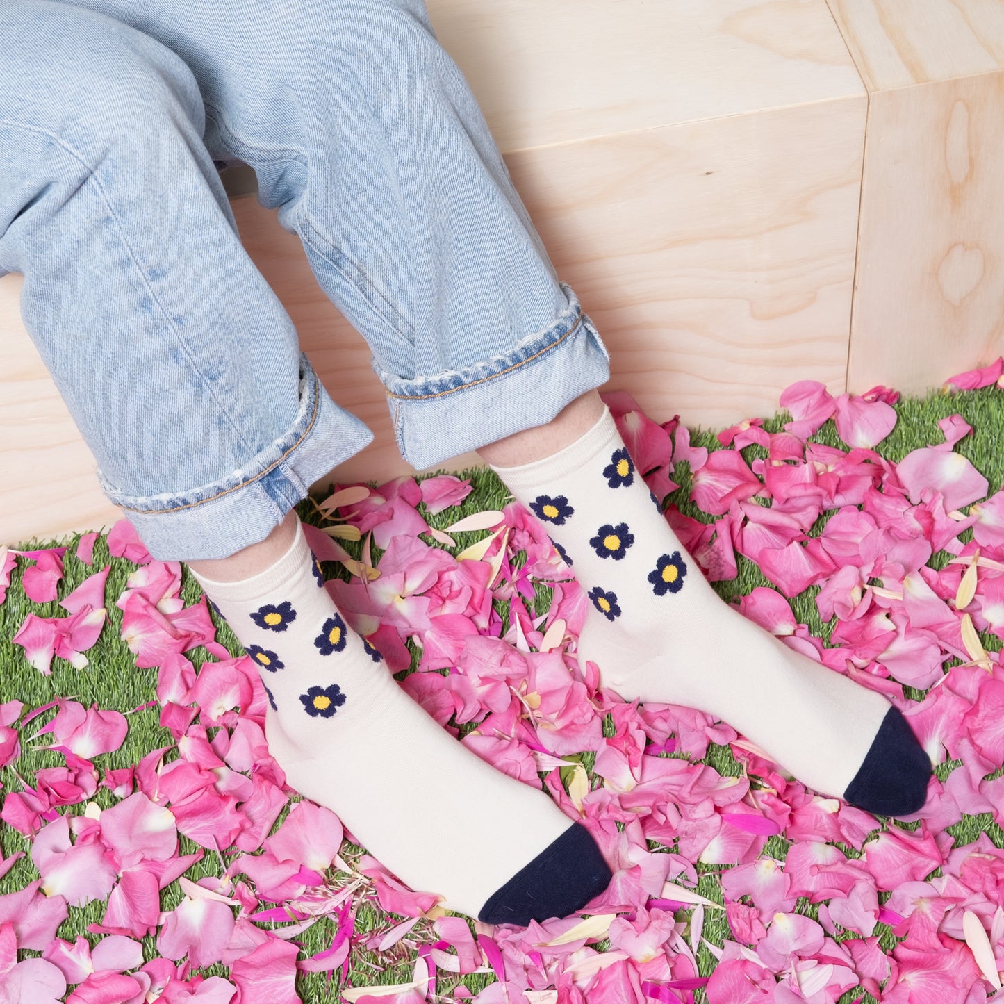 woman wearing luxurious white ankle sock with navy floral dots pattern with blue jeans